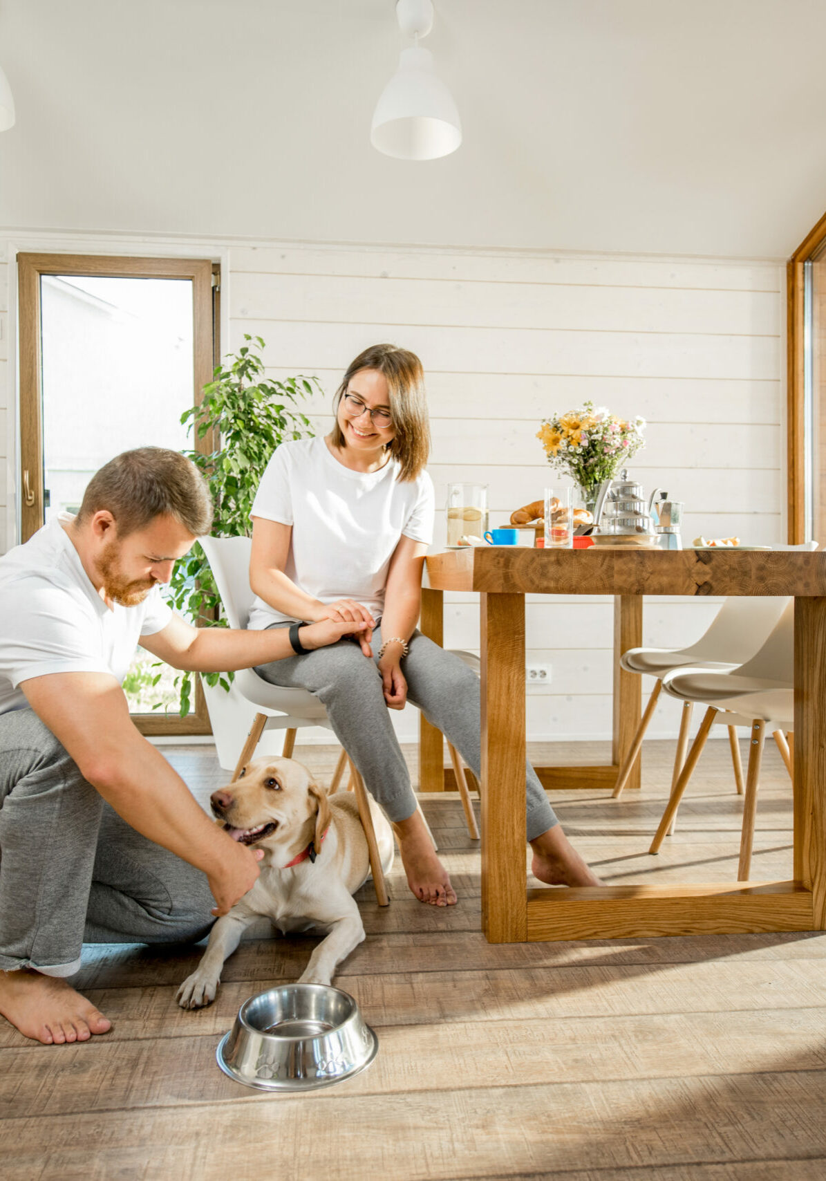 Young couple with dog at home | Floor to Ceiling Mason City